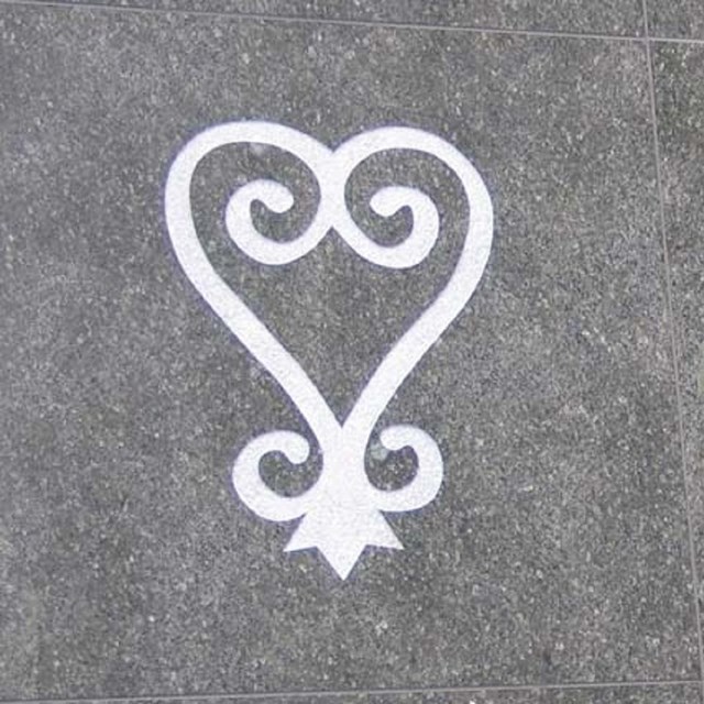 Heart symbol and part of an inscription on a memorial wall