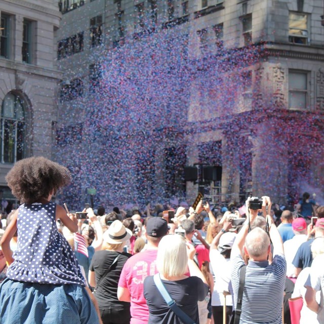 people gathered at a downtown with confetti 