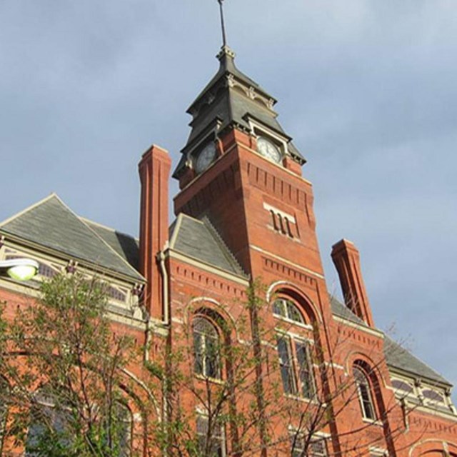 Tall brick building with a prominent clock tower