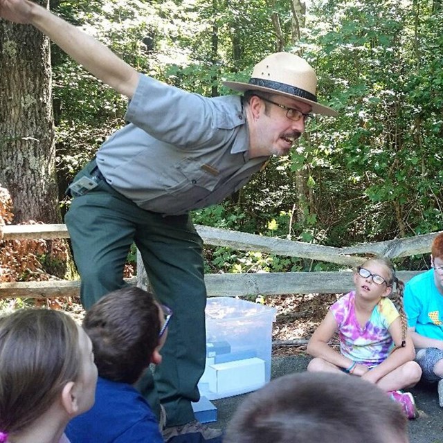 Students watching a ranger during their field trip. 