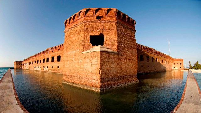 fisheye lens view of brick fort rising out of the ocean