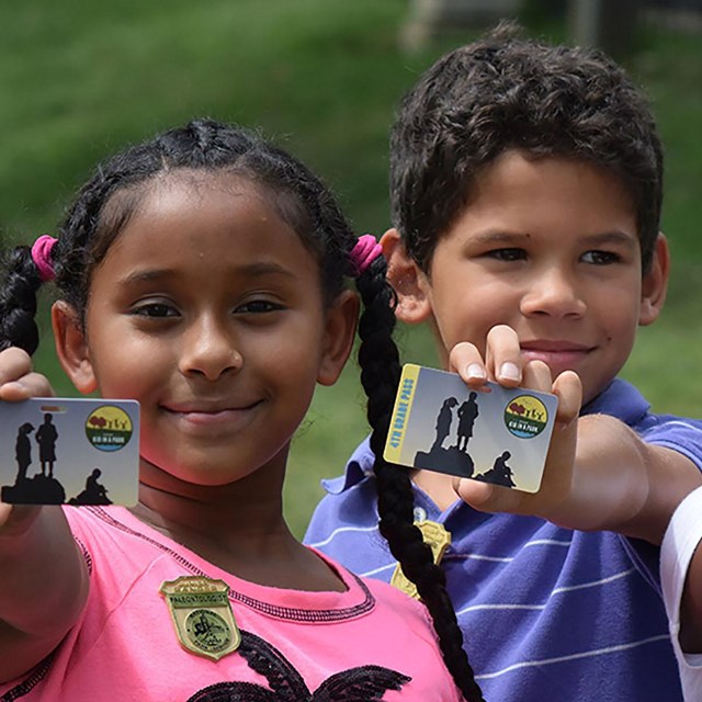 junior ranger badges on vest and hat of young students