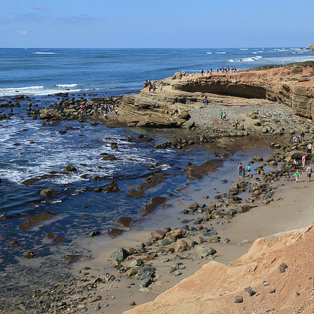 People by a rocky shore