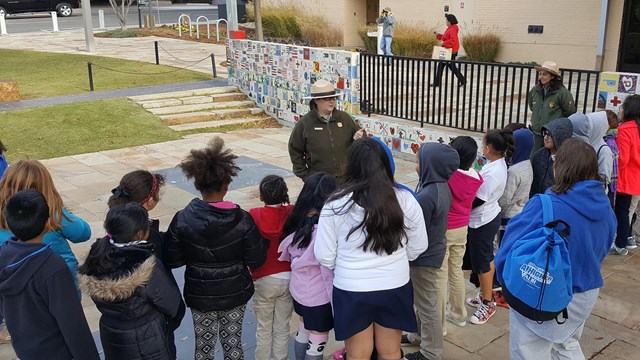 A park ranger talks to a group of students
