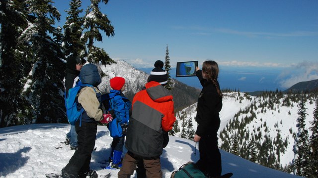 Ranger showing image before visiting audience.