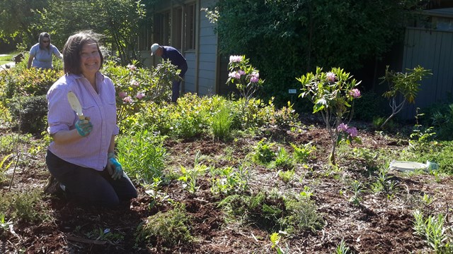 Woman poses with gardening shovel at the Olympic NP Visitor Center in Port Angeles