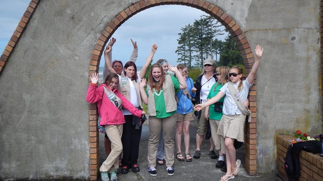 Girl Scout troop poses for picture after cleaning a beach
