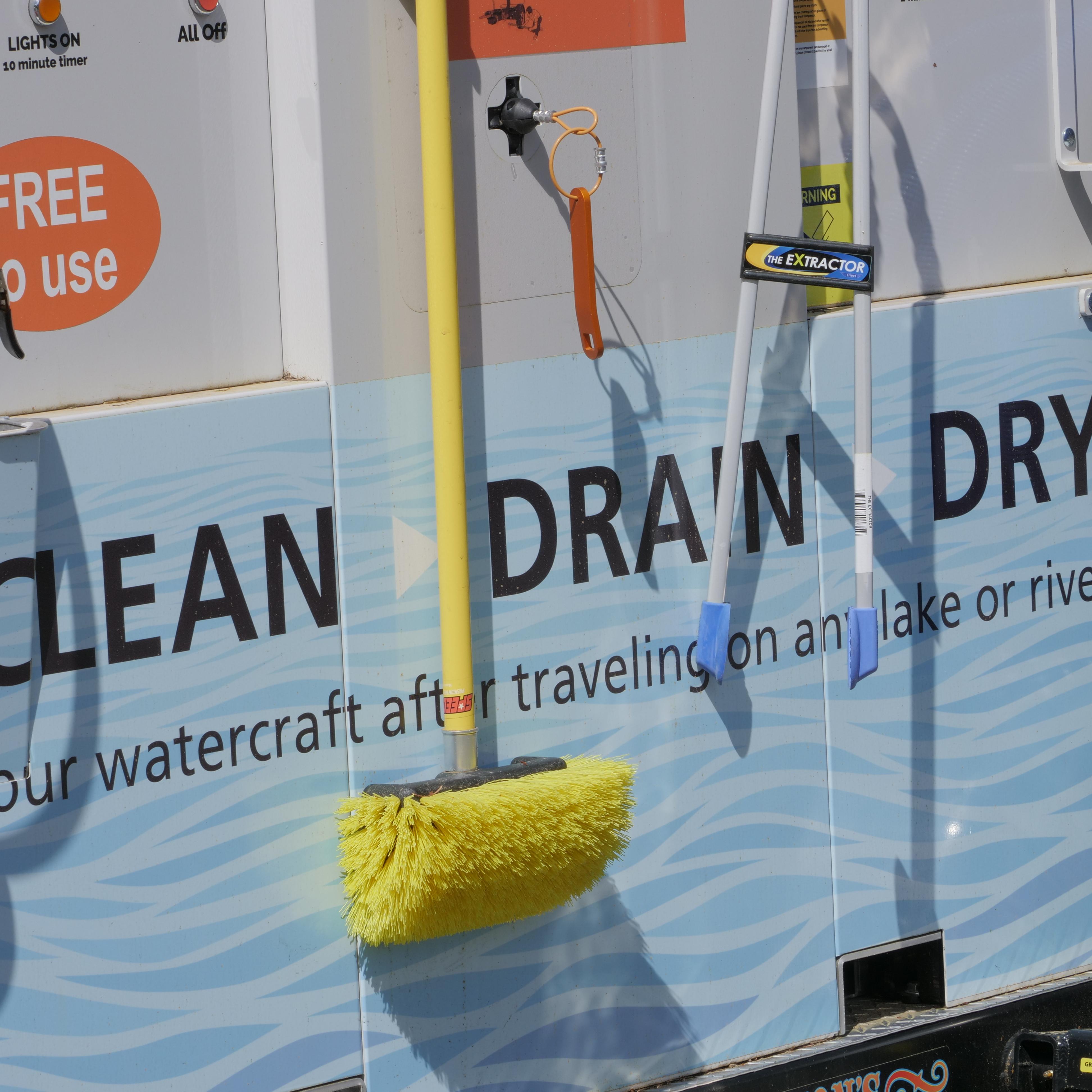 A small trailer with hoses and brushes, the words 