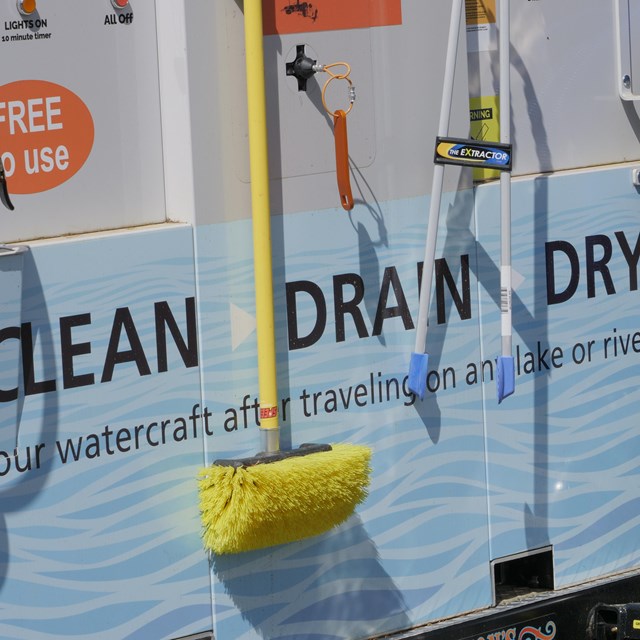 A small trailer with hoses and brushes, the words 