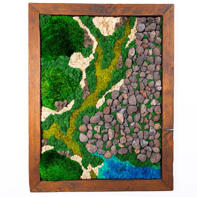 A large wood frame borders a moss wall in which rocks and moss of different colors are arranged to d