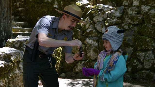 Oregon Caves park ranger using acid on marble to show a child how the caves were formed.