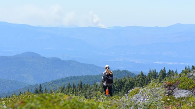 Hiker viewing smoke from a wild fire from the Mount Elijah trail.