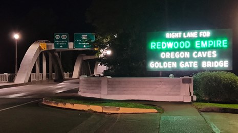 Redwoods, Oregon Caves, and Golden Gate road sign