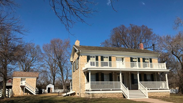 A historic two-story home with a large covered front porch.