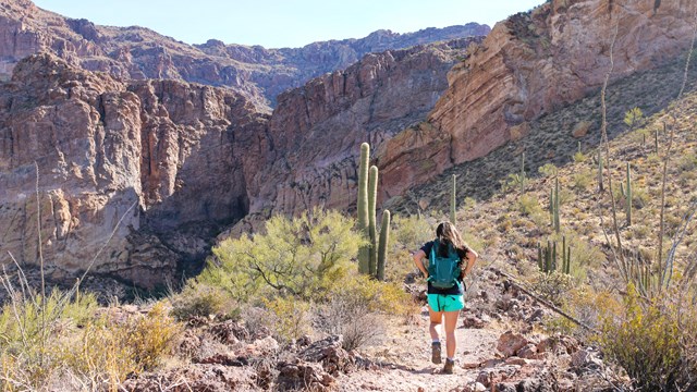woman hiking on a desert trail