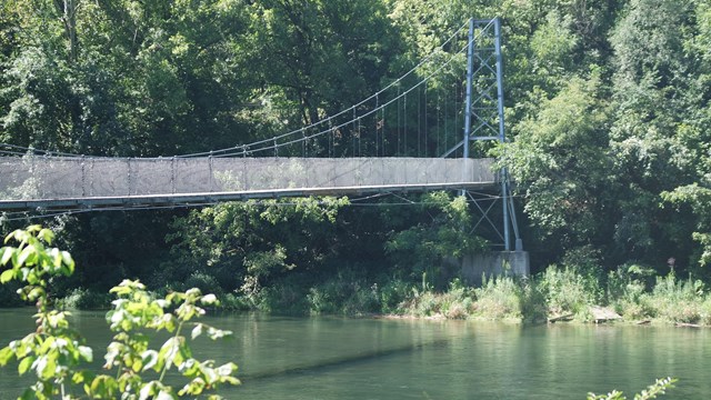 A suspension bridge crossing a river