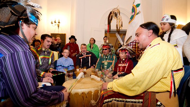 a group of native Americans in a drum circle