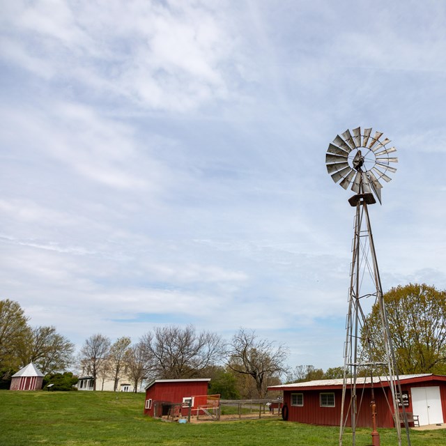 red barns and a metal silo on a farm