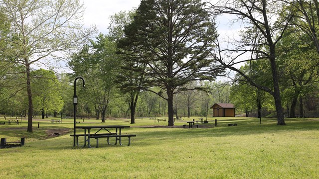 A freshly mown campground sits empty, ready for campers.