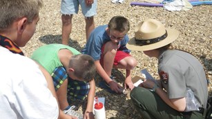 Ranger conducts program with kids on the gravel bar