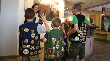 Children wearing vests with Jr. Ranger badges on them
