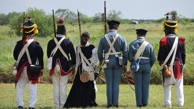 Living historians dressed in Mexican War era military uniforms