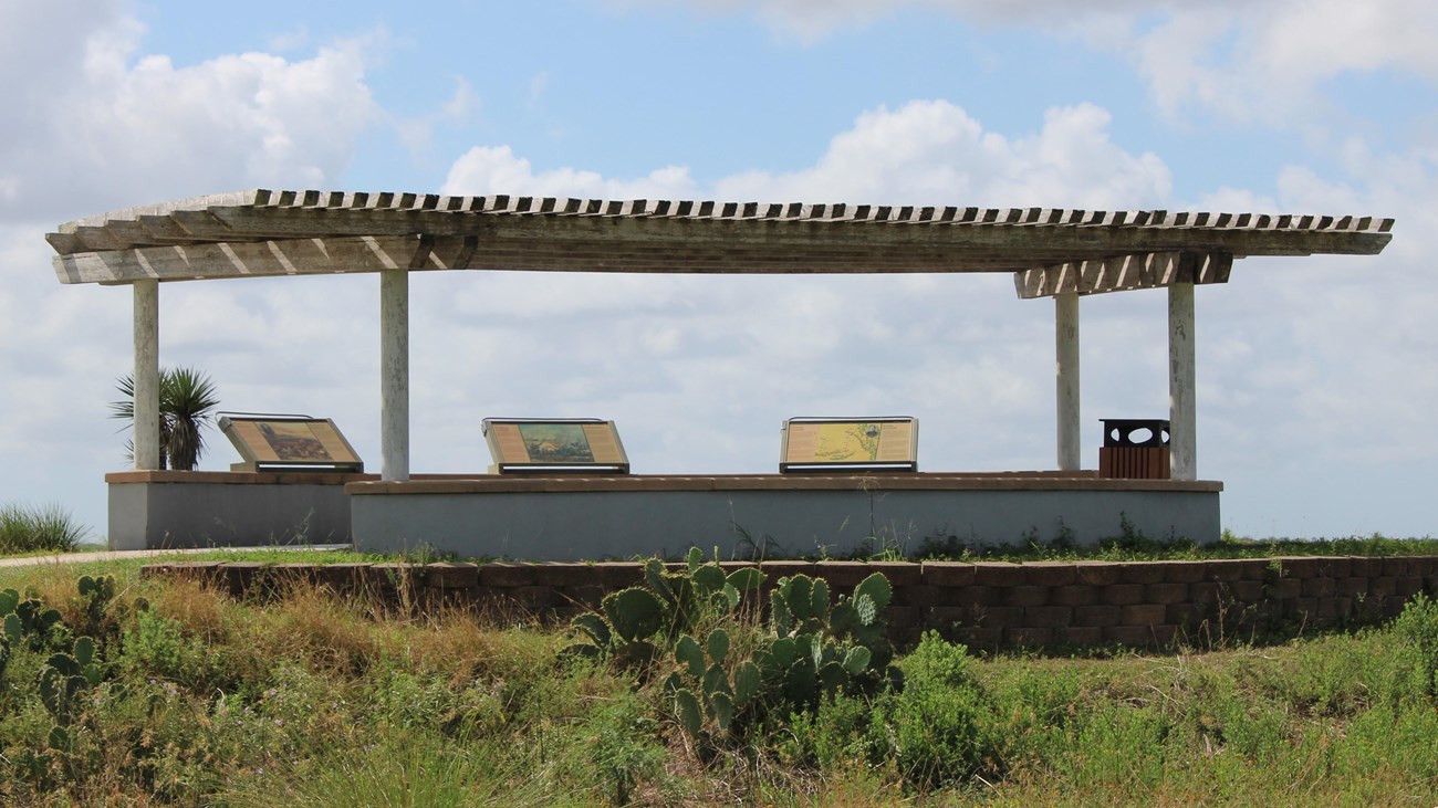 Circular, concrete battlefield overlook with three interpretive waysides and a wooden pergola.