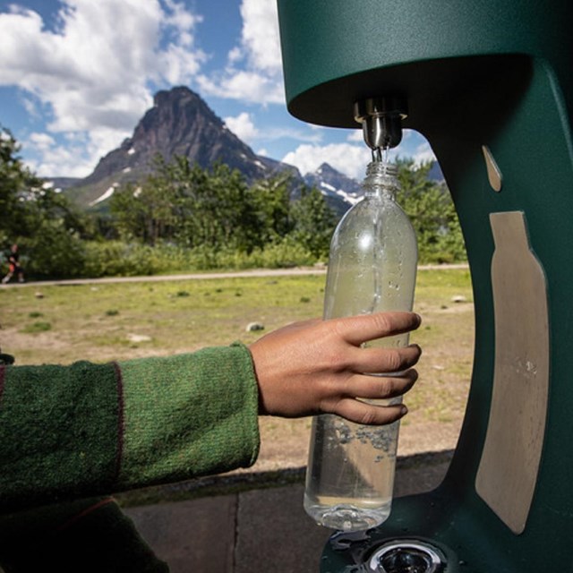 a water bottle filling station is used to refill a water bottle