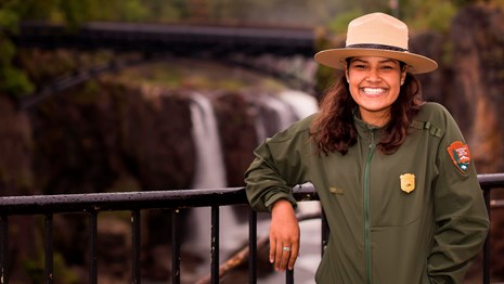 Ranger Sarai pictured with Great Falls in background. Photo Credit: Wander Tapia