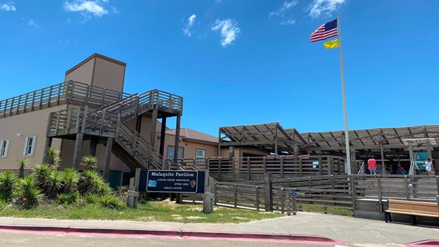 A large building surrounded by a wooden deck. 