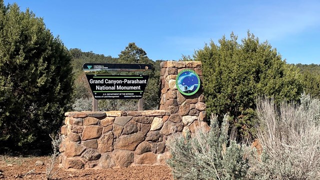 Monument boundary sign for Parashant. Sign is mounted on a rock base.