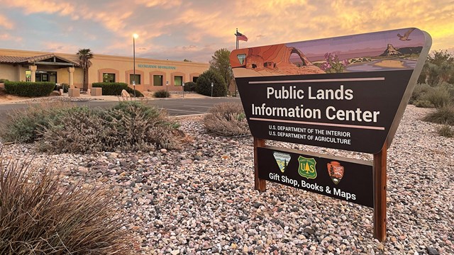 Welcome sign in front of the Public Lands building at sunrise. 