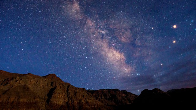 View of the Milky Way over the rocky landscape of Whitmore Point.