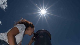 Park visitor enjoys view of moon through telescope at Rocky Mountain National Park