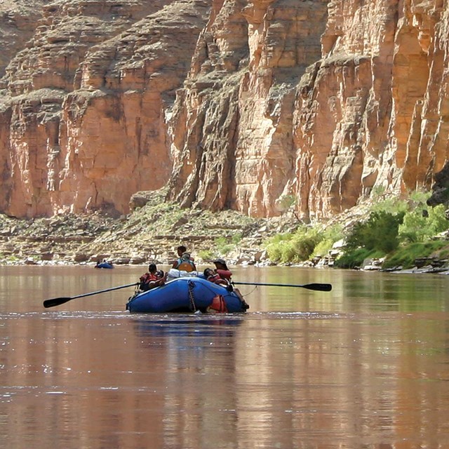 A kayak floats down the river at the bottom of the Grand Canyon. NPS photo.