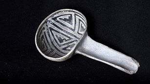 Ancient black on white ladle artifact