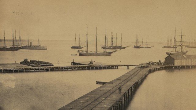 Boats in the water beyond a warf.