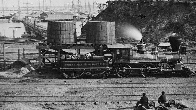 Steam train engine with text on the side United States Military Railroad.