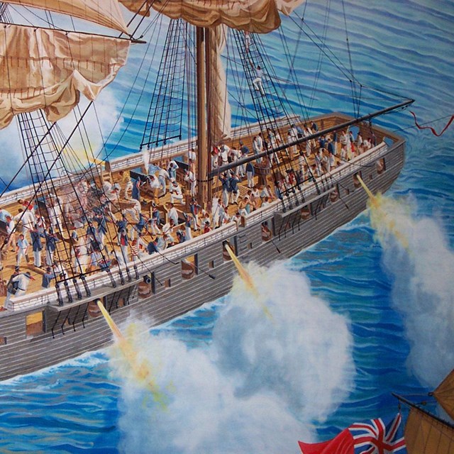 The isolated image of a ship from a brightly painted mural, firing cannons from both sides