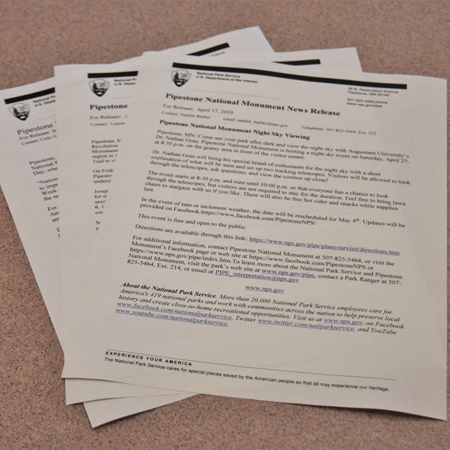 3 sheets of press releases on a table