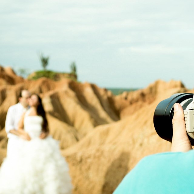 a crouched man taking a photo 