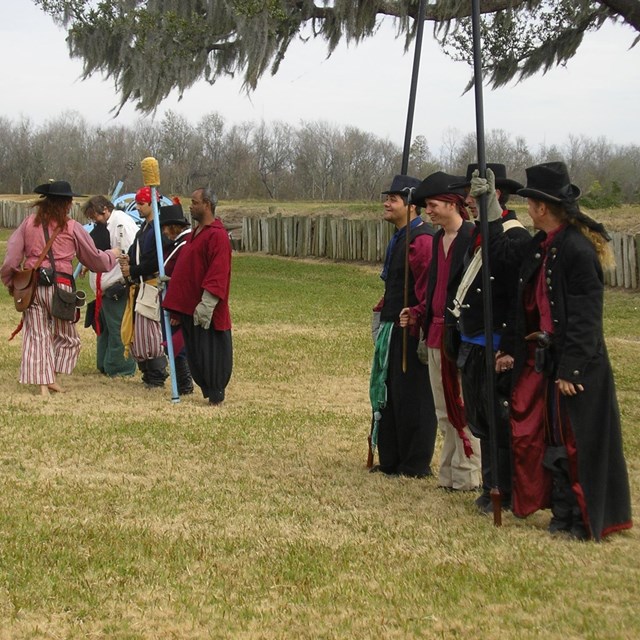 reenactment of spanish soldiers on grassy field
