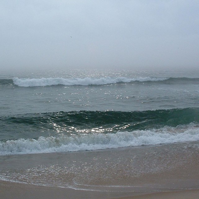 crashing ocean waves on beach