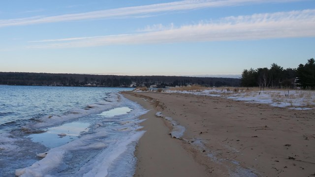 A beach with snow and ice.