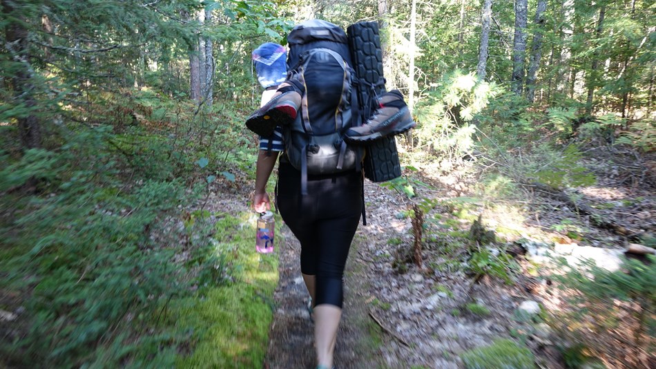 Backpacker going down the trail