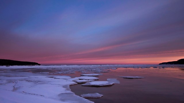 Sunrise over chunks of ice floating in Munising Bay