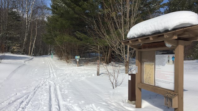 Cross country ski trailhead in Munising with ski tracks nearby