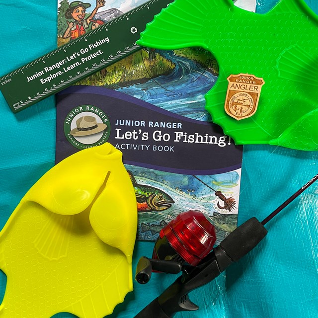 Junior Ranger Angler booklet, fish toys, fishing pole, and junior ranger angler badge