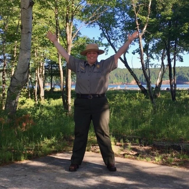 Park Ranger playing with a set of logs on the floor.