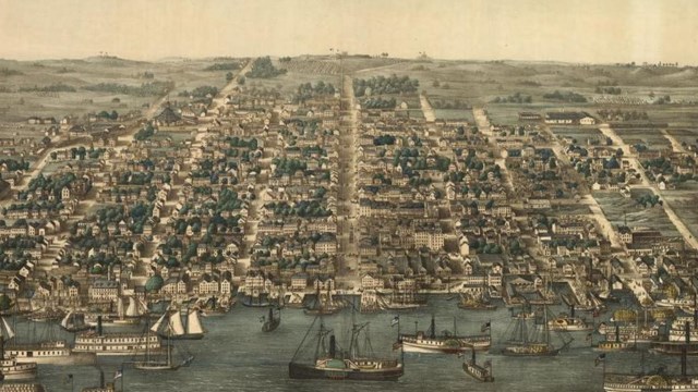Cityscape packed with buildings in front of a port full of boats